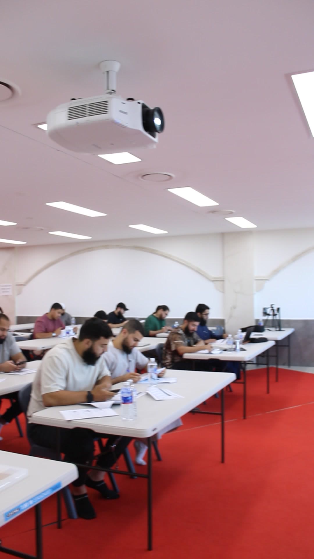 Rows of Shurayh students working at their tables